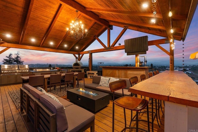deck featuring an outdoor living space with a fire pit and an outdoor kitchen