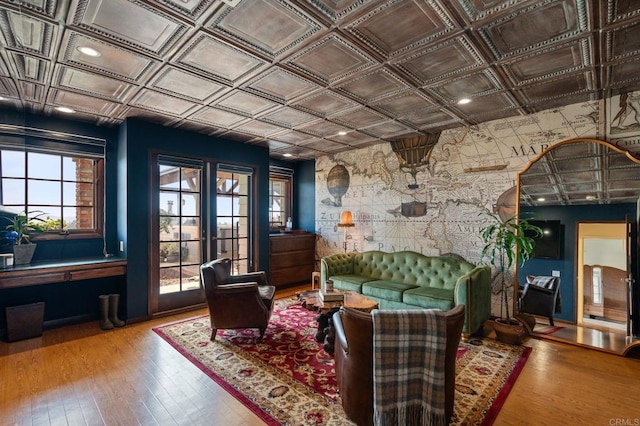 sitting room featuring an ornate ceiling and hardwood / wood-style flooring