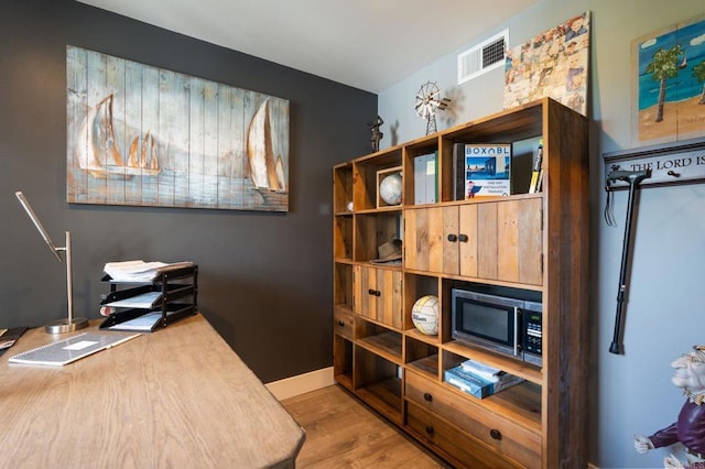 office space featuring wood finished floors and baseboards