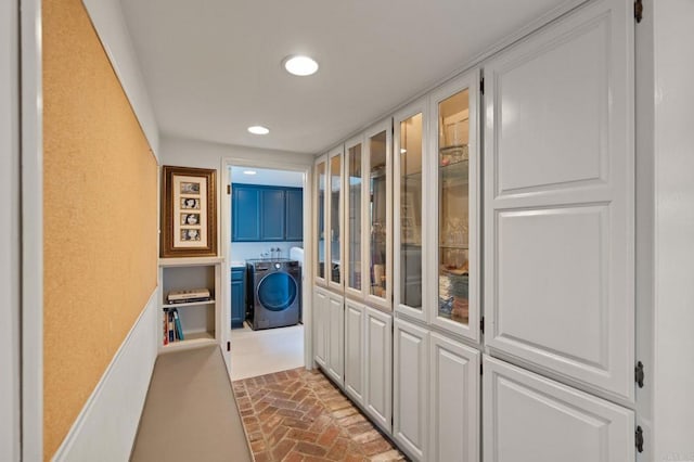 hallway with recessed lighting and brick floors
