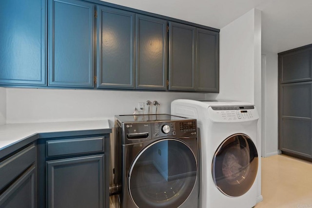 clothes washing area with cabinet space and independent washer and dryer
