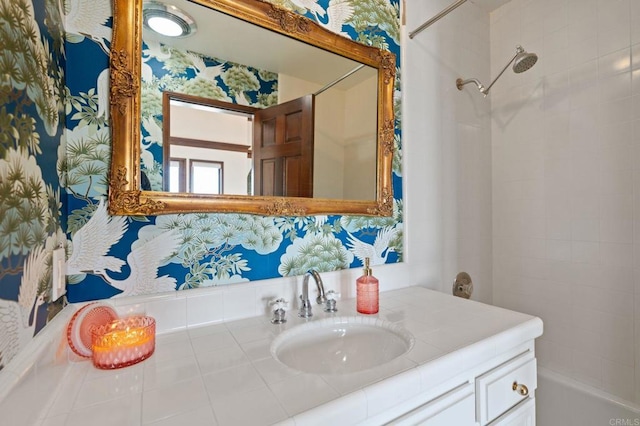 bathroom with a shower, vanity, and wallpapered walls