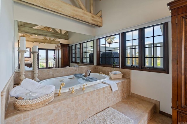 full bath with a bath, tile patterned flooring, and baseboards