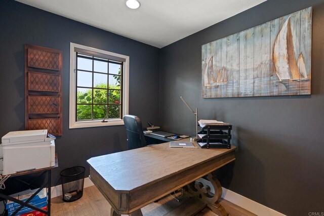 office area with baseboards and wood finished floors