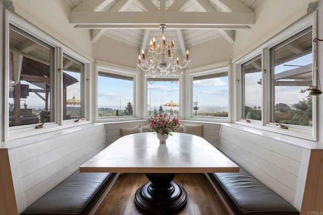 sunroom / solarium featuring a chandelier