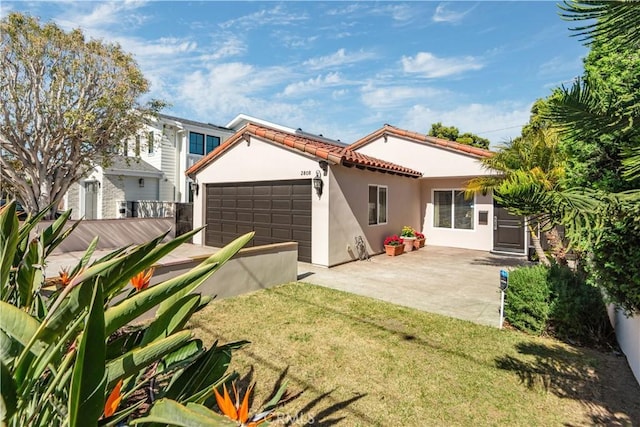 2808 Oak Ave, Manhattan Beach, CA 90266 - back of house featuring stucco siding, an attached garage, driveway, and a tiled roof