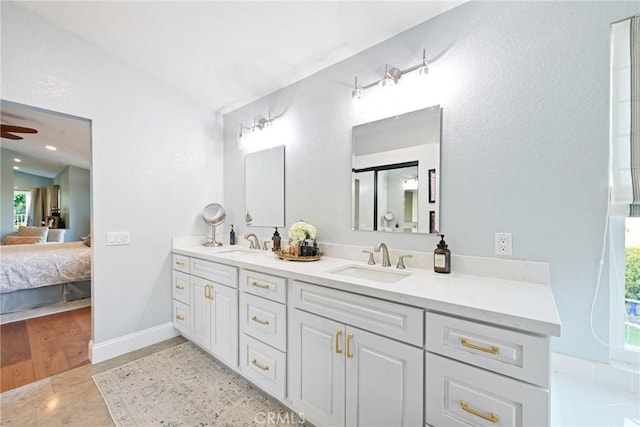 bathroom featuring connected bathroom, double vanity, and ceiling fan