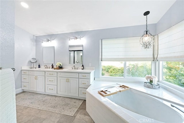 bathroom featuring healthy amount of natural light, double vanity, and a garden tub