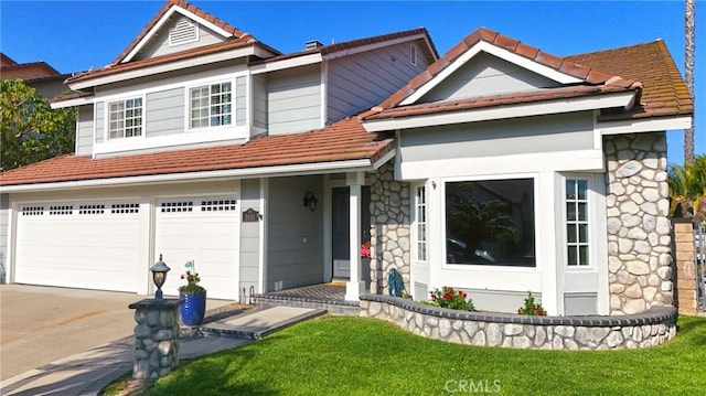 view of front of home featuring a tile roof, stone siding, a garage, concrete driveway, and a front lawn