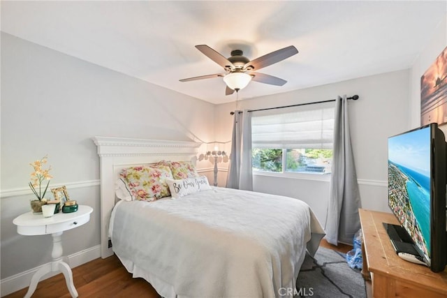 bedroom with wood finished floors, a ceiling fan, and baseboards