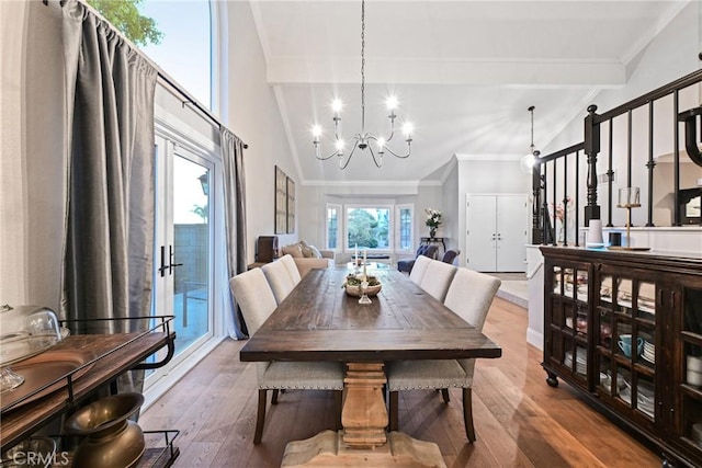dining room featuring a chandelier, ornamental molding, wood-type flooring, beamed ceiling, and high vaulted ceiling