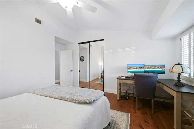 bedroom featuring wood finished floors, a desk, a closet, vaulted ceiling, and a ceiling fan