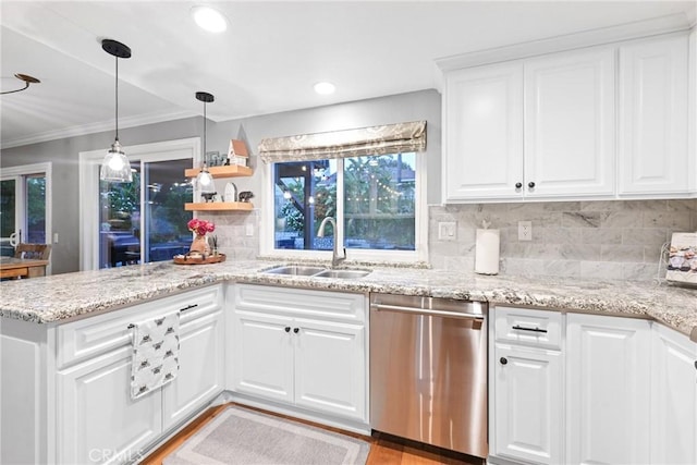 kitchen with dishwasher, a sink, backsplash, white cabinets, and light stone countertops