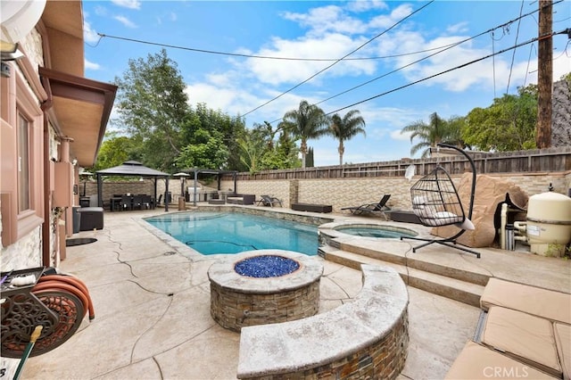 view of pool with a gazebo, a patio area, a fenced backyard, and a pool with connected hot tub