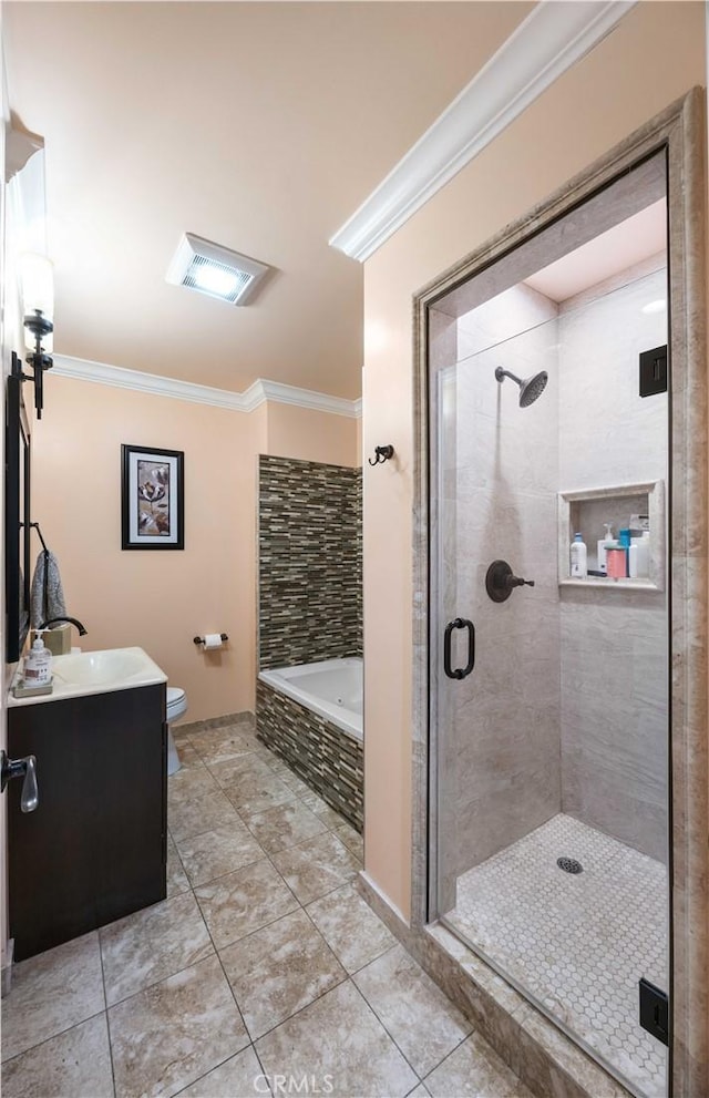 full bathroom featuring crown molding, a stall shower, a bath, toilet, and vanity