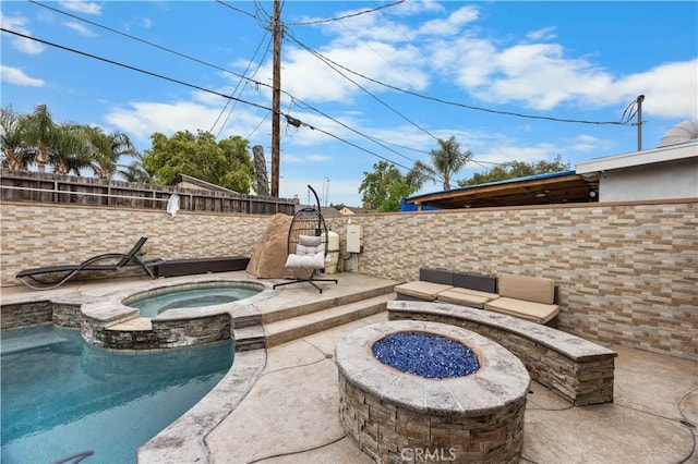 view of patio with an outdoor fire pit, a fenced backyard, and a pool with connected hot tub