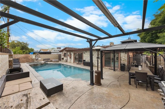 view of pool featuring a gazebo, a pool with connected hot tub, a patio, and fence