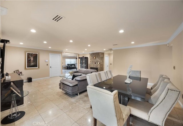 dining room featuring ornamental molding, recessed lighting, baseboards, a tile fireplace, and light tile patterned floors