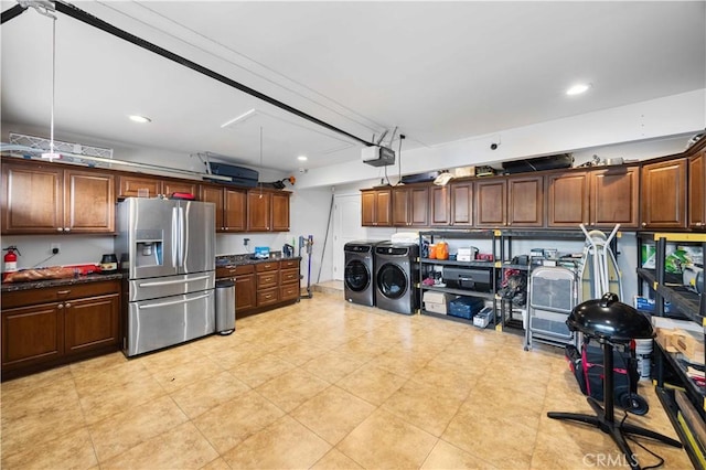 kitchen with stainless steel fridge, washing machine and clothes dryer, dark countertops, and recessed lighting