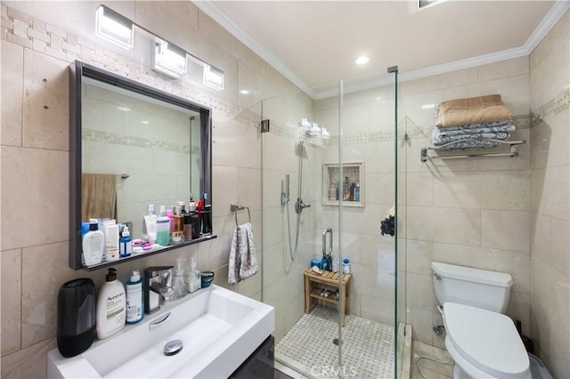 full bath with tile walls, ornamental molding, a shower stall, toilet, and vanity