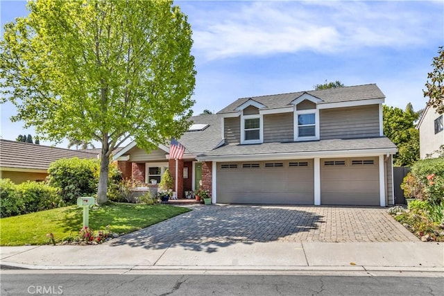 25572 Saltwater Dr, Dana Point, CA 92629 - traditional-style house with a garage, a front lawn, decorative driveway, brick siding, and roof with shingles