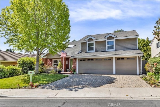25572 Saltwater Dr, Dana Point, CA 92629 - traditional home with an attached garage, a front yard, decorative driveway, brick siding, and roof with shingles
