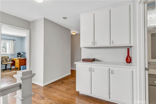 25572 Saltwater Dr, Dana Point, CA 92629 - kitchen with light countertops, light wood-type flooring, white cabinets, and an office area