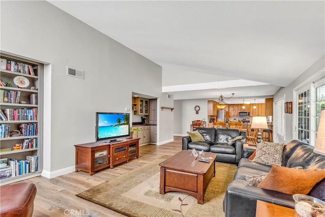 25572 Saltwater Dr, Dana Point, CA 92629 - living area featuring light wood-style floors, baseboards, and high vaulted ceiling
