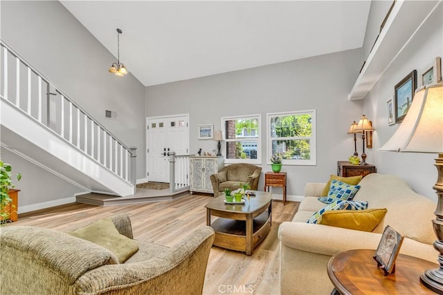25572 Saltwater Dr, Dana Point, CA 92629 - living area featuring high vaulted ceiling, stairway, light wood-style flooring, and baseboards