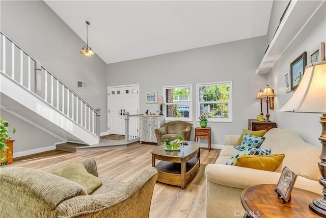 25572 Saltwater Dr, Dana Point, CA 92629 - living area with high vaulted ceiling, stairway, and light wood-style flooring