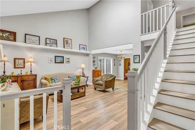 25572 Saltwater Dr, Dana Point, CA 92629 - living area featuring high vaulted ceiling, light wood-style floors, stairway, and a chandelier