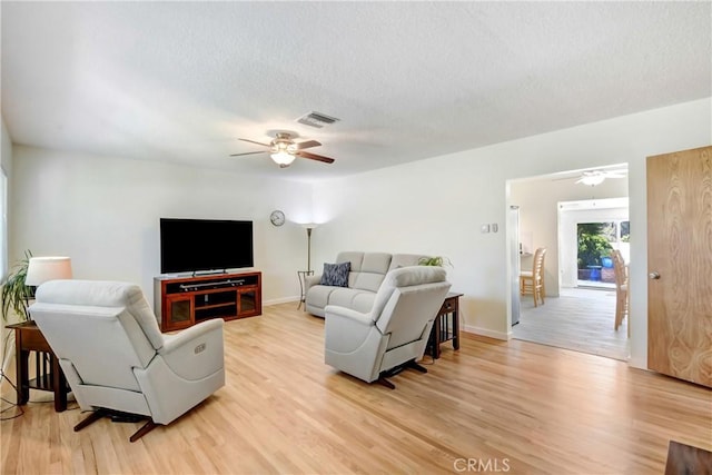 39671 Cherry Valley Blvd, Cherry Valley, CA 92223 - living room with light wood-style floors, a ceiling fan, a textured ceiling, and baseboards