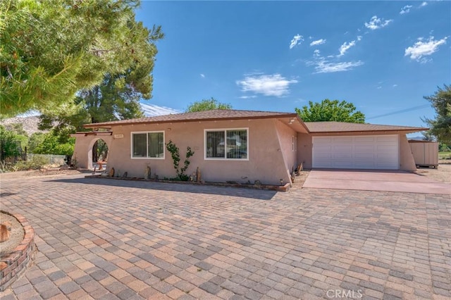 54955 Benecia Trl, Yucca Valley, CA 92284 - ranch-style home with stucco siding, driveway, and an attached garage