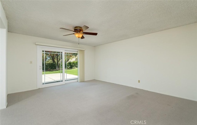 carpeted empty room with ceiling fan and a textured ceiling