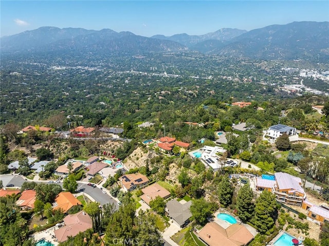 aerial view of property's location with a mountainous background and a pool area
