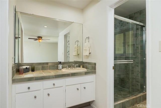 bathroom featuring a stall shower, vanity, ceiling fan, and recessed lighting