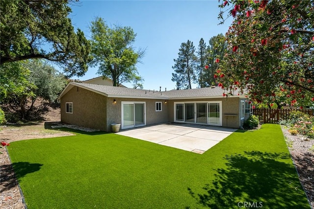 back of house with stucco siding and a patio area