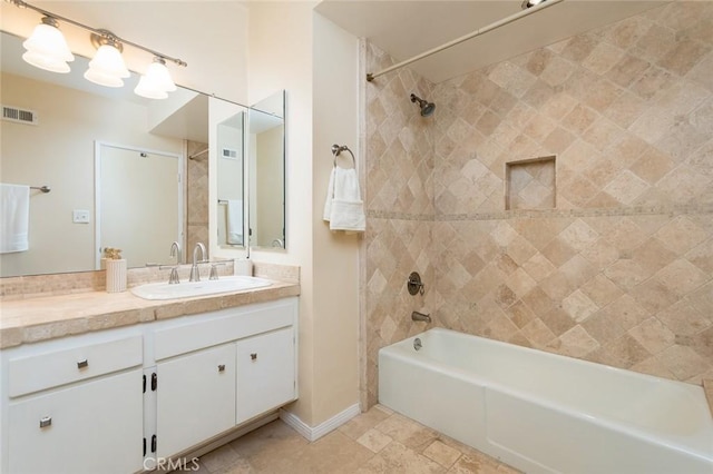 bathroom featuring shower / bath combination, vanity, and baseboards