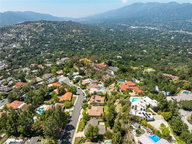 aerial view of property and surrounding area with a mountain backdrop