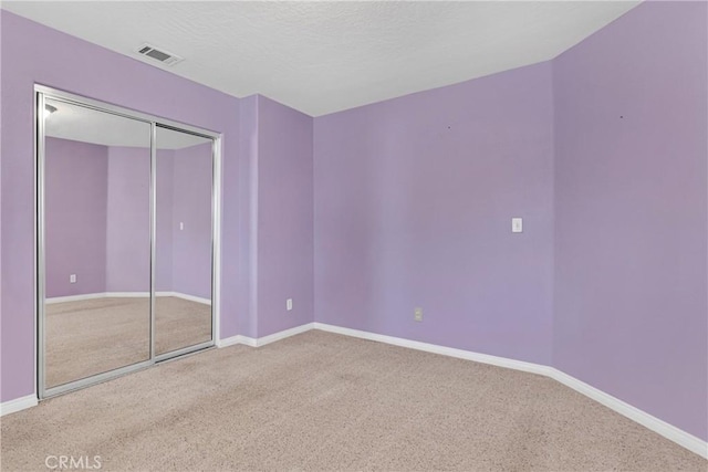 13935 Rincon Rd, Apple Valley, CA 92307 - unfurnished bedroom with carpet floors, baseboards, and a closet