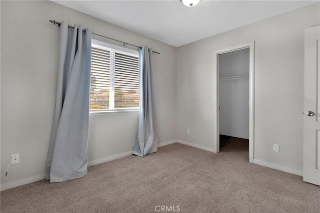 13935 Rincon Rd, Apple Valley, CA 92307 - unfurnished bedroom with carpet flooring, a walk in closet, and baseboards