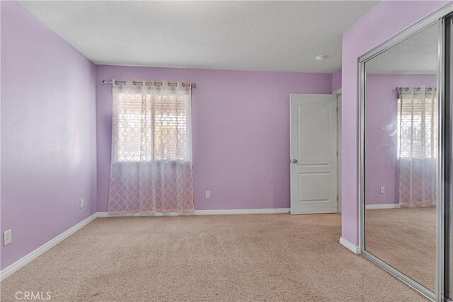 13935 Rincon Rd, Apple Valley, CA 92307 - carpeted empty room with baseboards