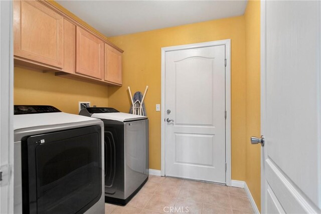 13935 Rincon Rd, Apple Valley, CA 92307 - washroom featuring washer and clothes dryer, cabinet space, baseboards, and light tile patterned floors