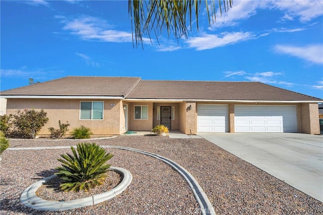 13935 Rincon Rd, Apple Valley, CA 92307 - ranch-style home featuring a garage, stucco siding, concrete driveway, and a tile roof