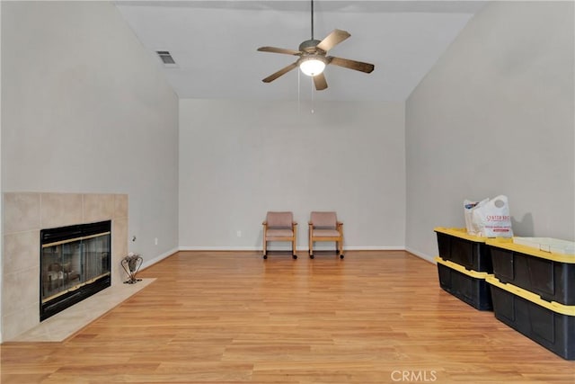 13935 Rincon Rd, Apple Valley, CA 92307 - living area with a ceiling fan, light wood-type flooring, a fireplace, vaulted ceiling, and baseboards