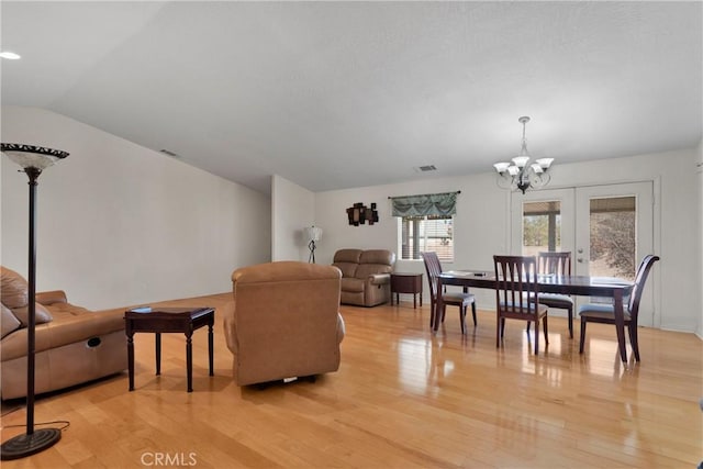 13935 Rincon Rd, Apple Valley, CA 92307 - living area with light wood-type flooring, a chandelier, vaulted ceiling, baseboards, and french doors