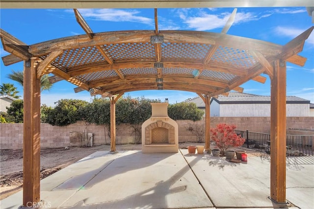 13935 Rincon Rd, Apple Valley, CA 92307 - view of patio featuring exterior fireplace and a fenced backyard