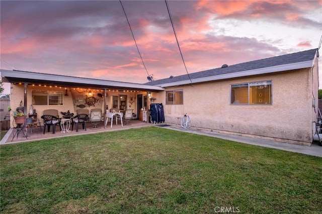 12653 Vandemere St, Lakewood, CA 90715 - rear view of property featuring stucco siding, a lawn, and a patio area