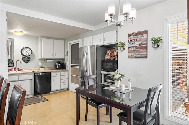 12653 Vandemere St, Lakewood, CA 90715 - kitchen featuring black appliances, a sink, and white cabinetry