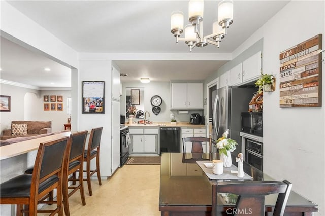 12653 Vandemere St, Lakewood, CA 90715 - kitchen with black appliances, a chandelier, light floors, light countertops, and white cabinets